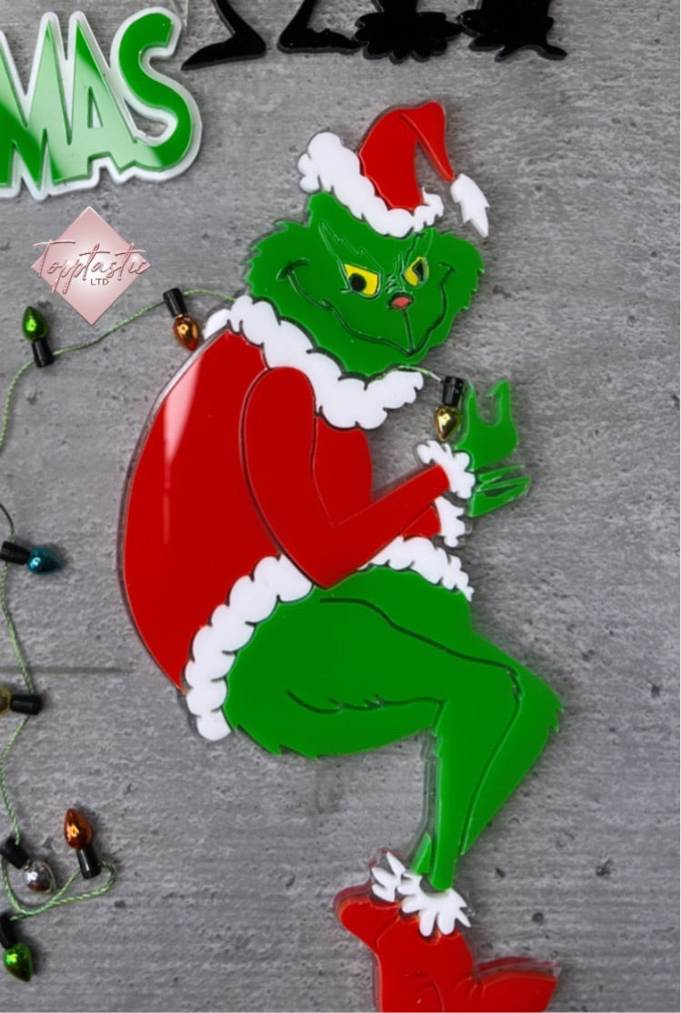 Grinch figure with string of lights